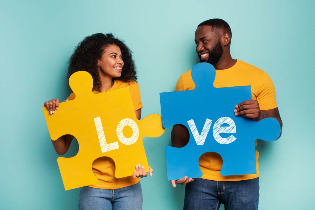 Married Couple Joining Puzzle Pieces Symbolizing Hyphenating Names